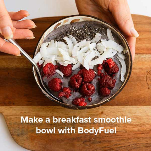 Smoothie bowl with flax seeds, coconut flakes and raspberries.