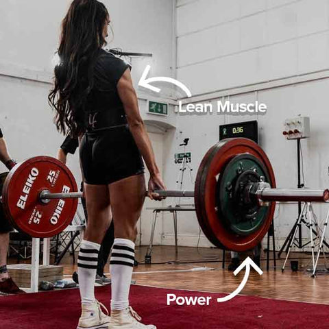 Women in knee high socks and black powerlifting singlet deadlifting.